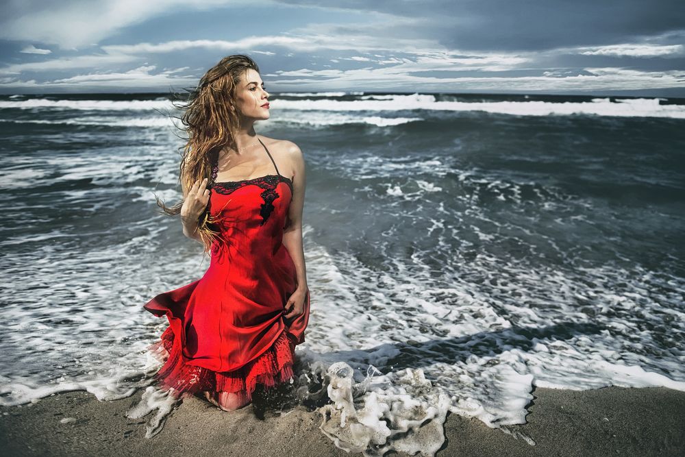Обои для рабочего стола Девушка в красном платье стоит на коленях на побережье у моря, by Alp Cem