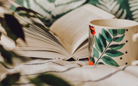 Обои на рабочий стол Чашка стоит у открытой книги, by Taisiia Shestopal