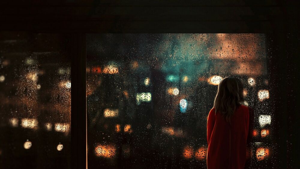 Обои для рабочего стола Девушка стоит перед окном, за которым ночной город под дождем, by BaxiaArt