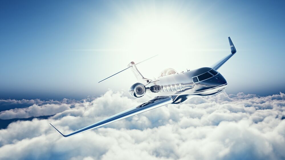 Обои для рабочего стола Learjet 45 частный самолет пролетает над облаками