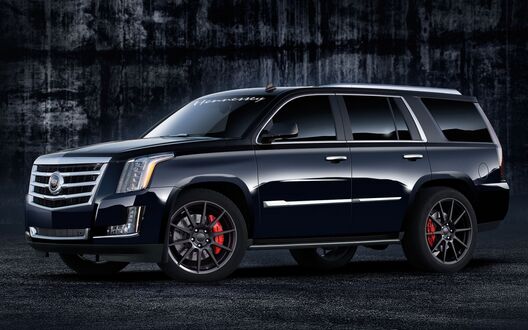 Обои на рабочий стол Черный Cadillac Escalade на асфальте у ангара сбоку