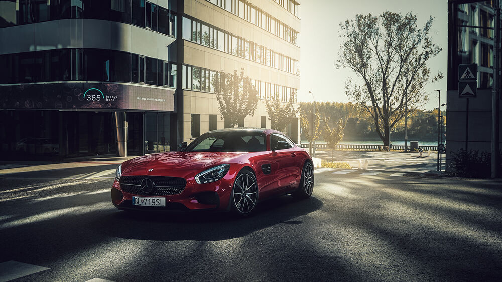 Обои для рабочего стола Красный Mersedes Benz на фоне города