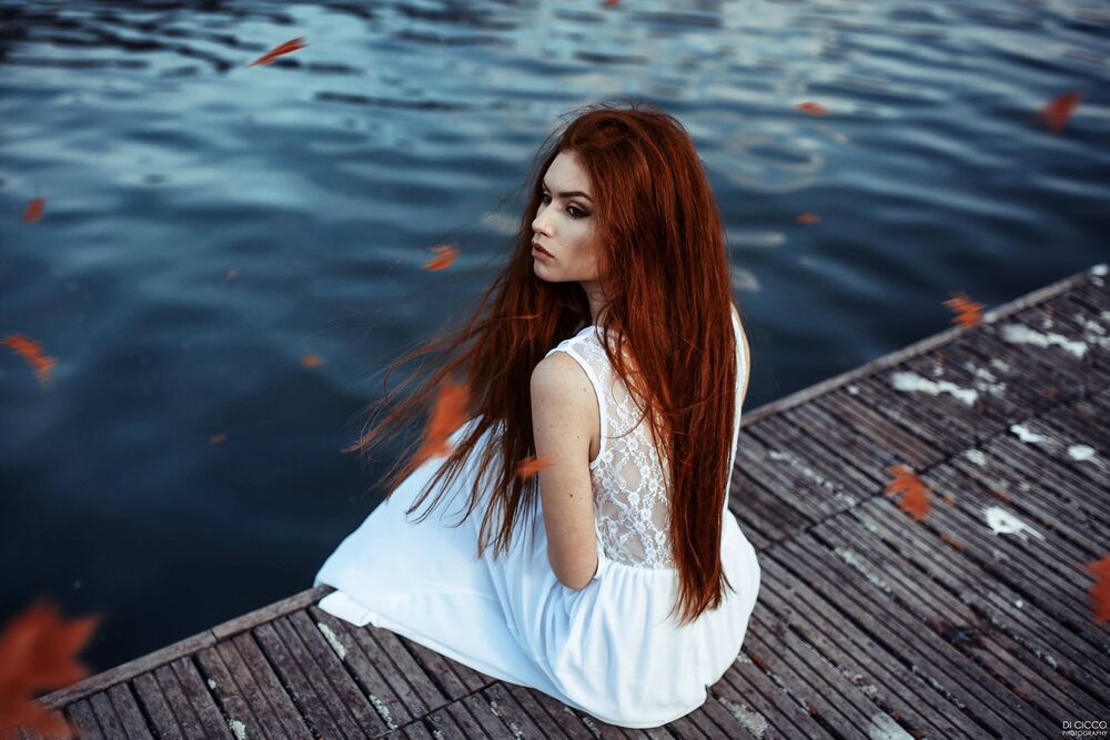 Обои для рабочего стола Модель Valentina Galassi в белом платье сидит на мостике у водоема