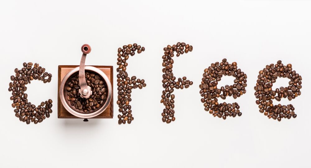 Обои для рабочего стола Слово coffee выложено из кофейных зерен на белом фоне