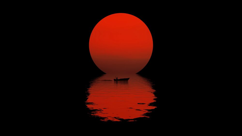 Обои для рабочего стола Лодка на воде на фоне красного солнца