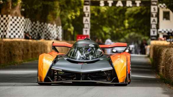 Обои на рабочий стол Черно-оранжевый McLaren Solus GT на гоночной трассе