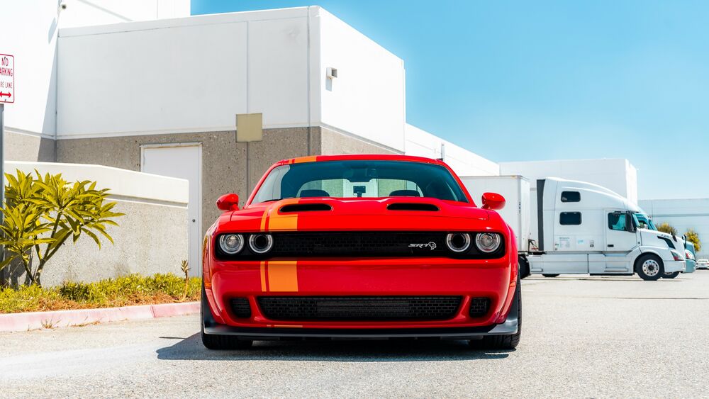 Обои для рабочего стола Красный Dodge Challenger SRT на улице у здания