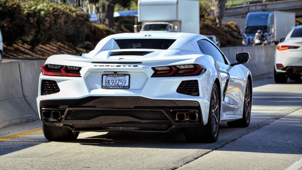 Обои для рабочего стола Белый Chevrolet Corvette на парковке, сзади