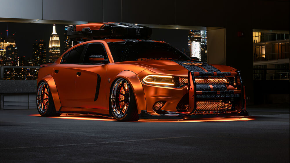 Обои для рабочего стола Тюнингованный Dodge Charger с оранжевыми неоновыми огнями на фоне ночного города