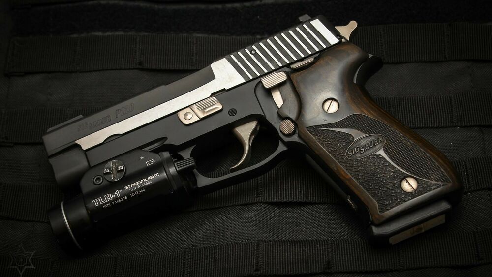 Обои для рабочего стола Пистолет Sig Sauer с тактическим фонарем на темном фоне
