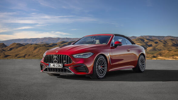 Обои на рабочий стол Красный автомобиль Mercedes-AMG CLE 53 4MATIC+ Cabriolet 2024 года на пустынной дороге среди холмов на закате