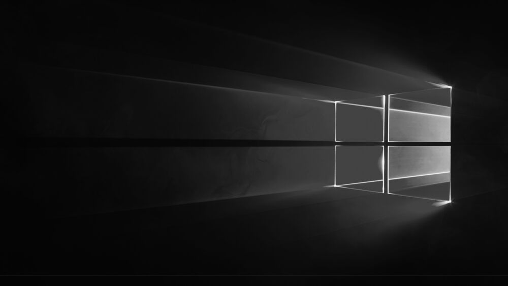 Обои для рабочего стола Логотип Windows в виде светящегося окна с преломляющимися лучами на черном фоне в минималистичном стиле