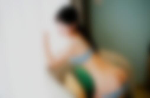 Обои для рабочего стола Девушка в светлом нижнем белье позирует, опираясь на белую штору, на плетеном кресле с желтой и зеленой подушками, на фоне бирюзовой стены
