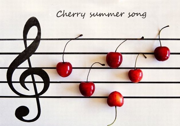 Фото На нотном стане вишенками - нотами выложена летняя песенка и надпись сherry summer song