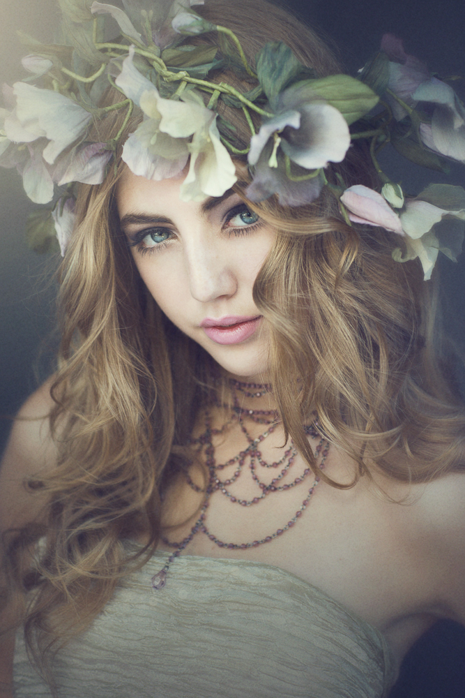Фото Портрет девушки блондинки с цветочным венком на голове и украшением на шее
