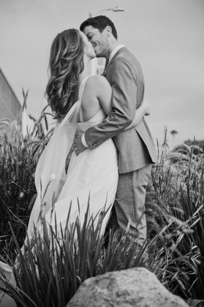 Фото Девушка с парнем целуются, стоя среди травы