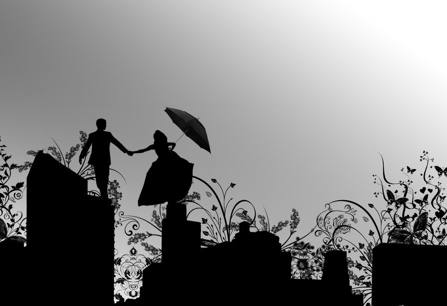Фото Силуэты девушки с зонтом и парня, стоящих на крыше домов