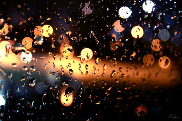 Фото Ночные блики через стекло в дождевых каплях
