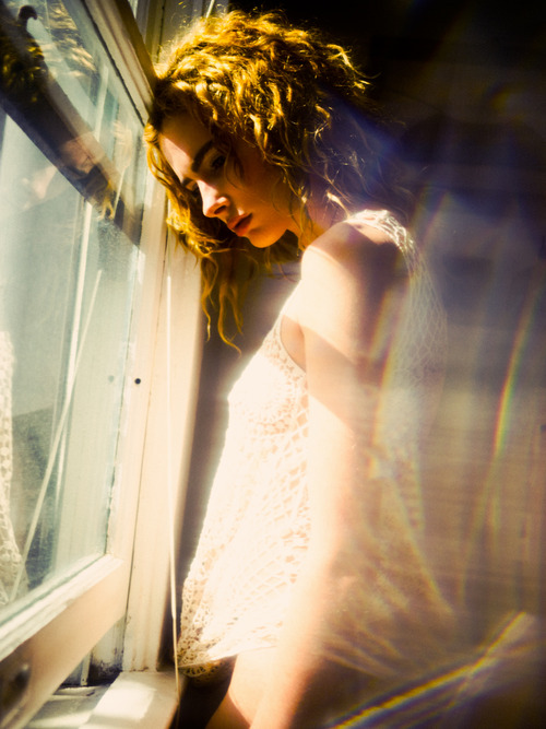Фото Задумчивая девушка стоит у окна