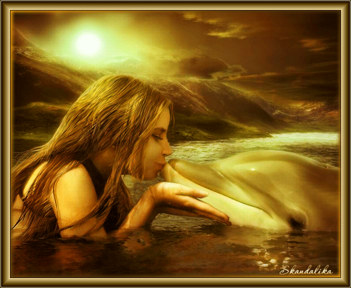 Фото В море девушка гладит и целует дельфина