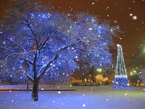Фото Дерево горит синенькими огоньками, идет снег