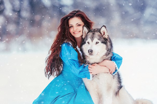 Фото Улыбающаяся девушка обнимает песика, оба сидят на снегу, фотограф Мария Полянская