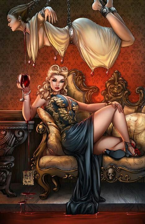 Фото Девушка сидит на диване с бокалом вина в руке, другая девушка подвешена на цепях к потолку