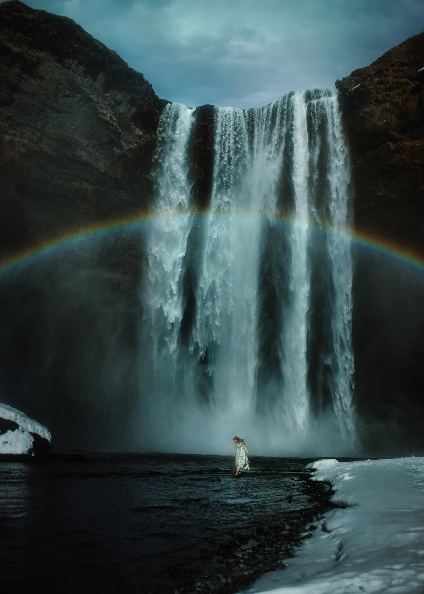Фото Девушка в белом платье стоит в воде на фоне огромного водопада с радугой, by TJ Drysdale