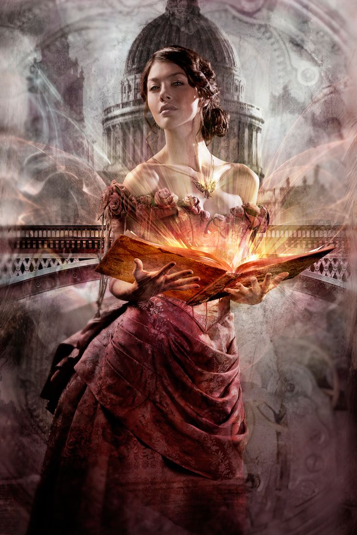 Фото Девушка в роскошном красном платье, украшенном розами, с украшением на шее в виде ангела держит в руках книгу, излучающую свет