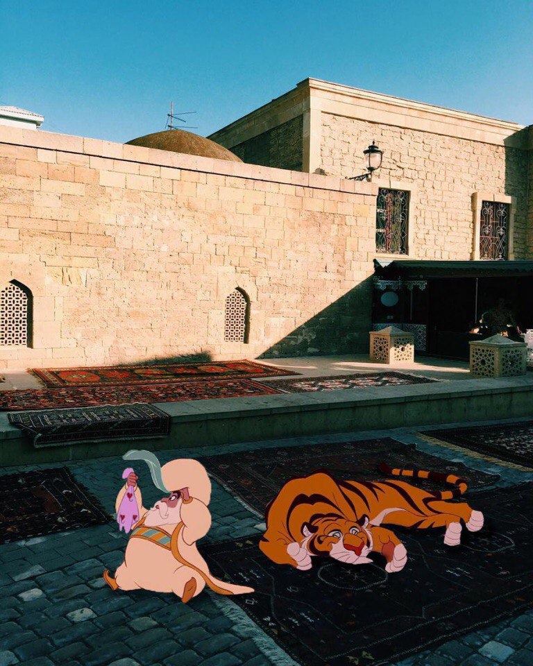 Фото Султан и тигр из мультфильма Аладдин расположились на тротуаре улицы в городе Баку