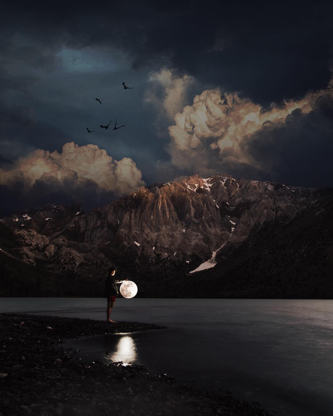 Фото Парень стоит у воды с луной в руках