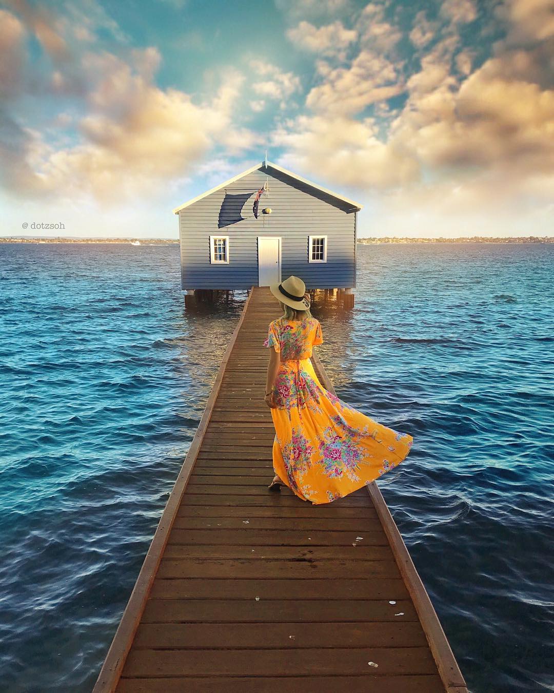 Фото Девушка в шляпе и длинном платье идет по мостику к домику над морем, by Dotz Soh