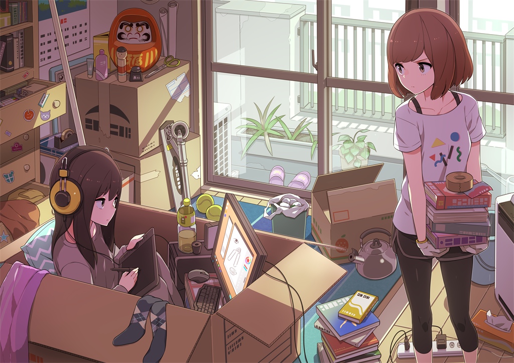 Фото Девушка в наушниках рисует на графическом планшете, сидя в большой коробке, другая девушка смотрит на нее недовольным взглядом, убирая книги на место