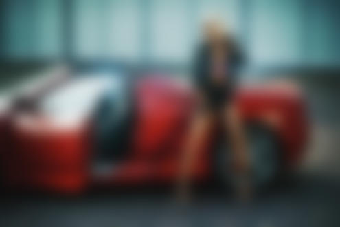 Фото Девушка - блондинка в кожаной курточке стоит у красного авто, by Jоrg Otto