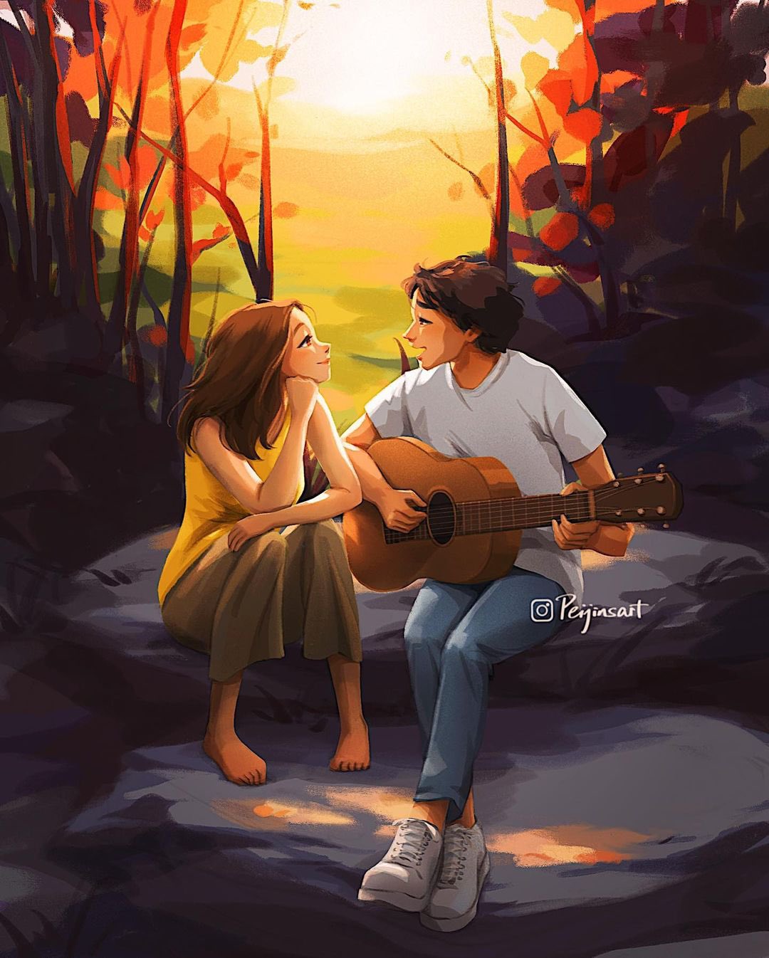 Фото Парень с девушкой сидят на камне и он играет на гитаре