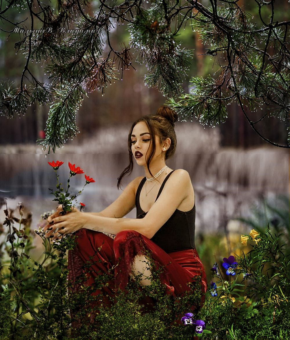 Фото Девушка под елью сидит держит в ладонях цветы