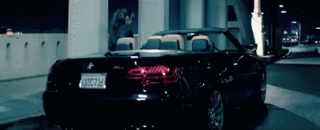 Анимация Девушка (певица Шерил Коул) садится в автомобиль BMW, заводит включает фары, едет в ночи