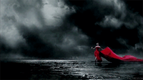 Анимация Девушка в платье с развевающимся красным шлейфом танцует на фоне облаков, гифка Девушка в платье с развевающимся красным шлейфом танцует на фоне облаков