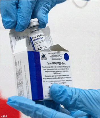 Анимация Вакцина против Covid-19 СПУТНИК-V (Гам-КОВИД-Вак) в руках у доктора, на фоне белого цветового оттенка с красным пятном в левом нижнем углу, гифка Вакцина против Covid-19 СПУТНИК-V (Гам-КОВИД-Вак) в руках у доктора, на фоне белого цветового оттенка с красным пятном в левом нижнем углу