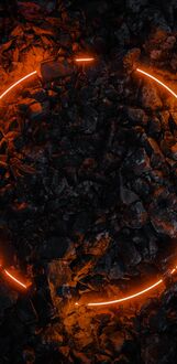 Обои на телефон Оранжевый неоновый круг, светящийся в темноте, лежит на неровной каменистой поверхности на фоне множества похожих темных камней