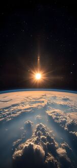 Обои на телефон Земля с облаками на переднем плане, яркое солнце светит над горизонтом, на фоне темного космоса со звездами